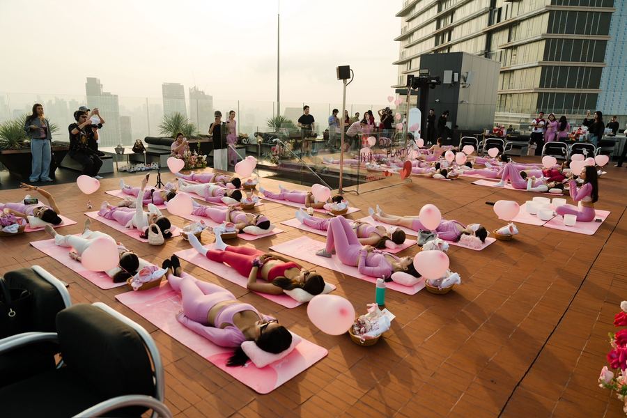 A rooftop brand launch sound bath in Bangkok at sunset with the skyline behind