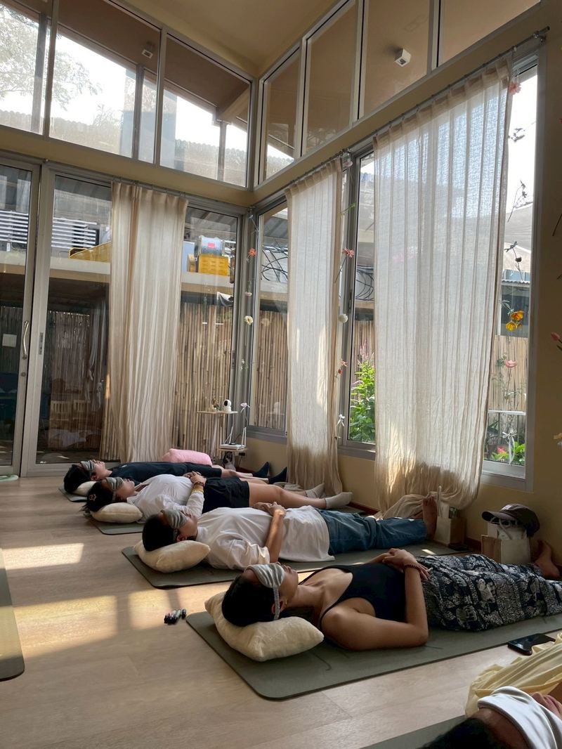 An indoor sound healing session underway in a bright Bangkok studio