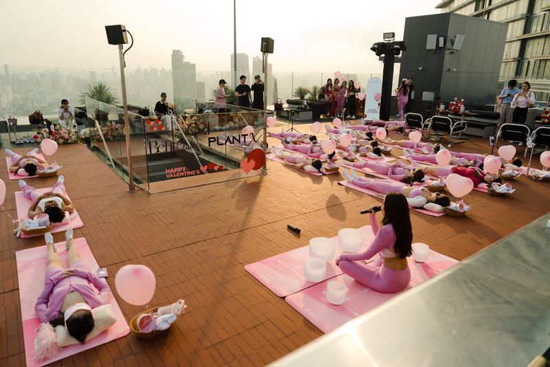 A branded rooftop sound bath in Bangkok with the city skyline behind