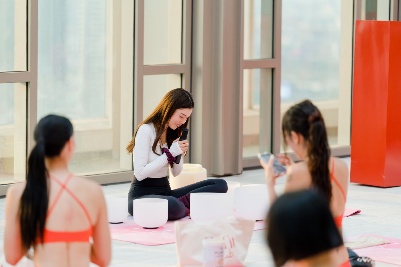 A facilitator setting out crystal singing bowls before guests arrive for a sound bath